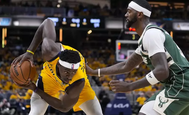 Indiana Pacers forward Pascal Siakam (43) looks to drive on Milwaukee Bucks forward Bobby Portis (9) during the second half in Game 2 in an NBA basketball first-round playoff series, Friday, April 26, 2024, in Indianapolis. (AP Photo/Michael Conroy)