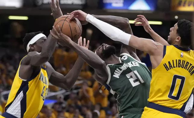 Indiana Pacers guard Tyrese Haliburton (0) blocks the shot of Milwaukee Bucks guard Patrick Beverley (21) during the first half in Game 2 in an NBA basketball first-round playoff series, Friday, April 26, 2024, in Indianapolis. (AP Photo/Michael Conroy)