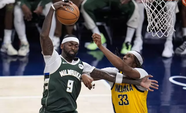 Milwaukee Bucks forward Bobby Portis (9) grabs a rebound in front of Indiana Pacers center Myles Turner (33) during the second half in Game 2 in an NBA basketball first-round playoff series, Friday, April 26, 2024, in Indianapolis. (AP Photo/Michael Conroy)