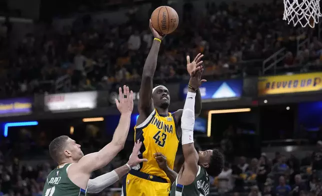 Indiana Pacers' Pascal Siakam (43) shoots over Milwaukee Bucks' Brook Lopez (11) and Malik Beasley during the second half of Game 4 of the first round NBA playoff basketball series, Sunday, April 28, 2024, in Indianapolis. (AP Photo/Michael Conroy)