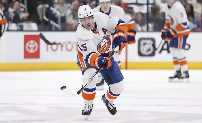 CORRECTS TO APRIL NOT MARCH - New York Islanders right wing Cal Clutterbuck (15) passes the puck during the first period of an NHL hockey game against the Columbus Blue Jackets, Thursday, April 4, 2024, in Columbus, Ohio. (AP Photo/Joe Maiorana)