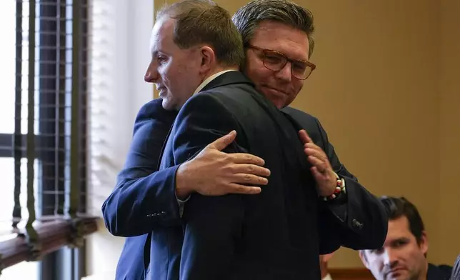 CORRECTS LAST NAME TO LEATHERWOOD, NOT LEATHER - Covenant School parent Brent Leatherwood, right, hugs attorney Eric Osborne, left, before a hearing to decide whether the journals of a Nashville school shooter can be released to the public, Tuesday, April 16, 2024, in Nashville, Tenn. (AP Photo/George Walker IV)