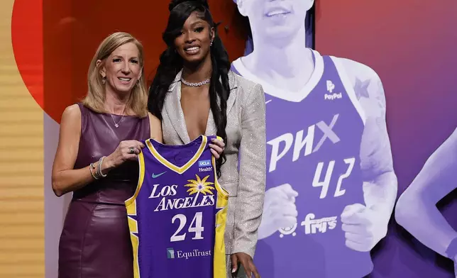 CORRECTS TO RICKEA INSTEAD OF RICK - Tennessee's Rickea Jackson, right, poses for a photo with WNBA commissioner Cathy Engelbert after being selected fourth overall by the Los Angeles Sparks during the first round of the WNBA basketball draft, Monday, April 15, 2024, in New York. (AP Photo/Adam Hunger)