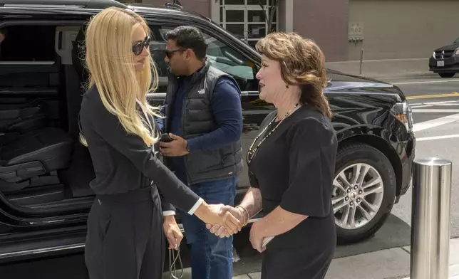 Hotel heiress and media personalty Paris Hilton, left, is greeted by State Sen. Shannon Grove, R-Bakersfield on her arrival in Sacramento, Calif., Monday, April 15, 2024. Hilton will appear before a state Senate committee in support of Grove's measure calling for greater transparency of youth treatment facilities licensed by the California Department of Social Services, (AP Photo/Rich Pedroncelli)