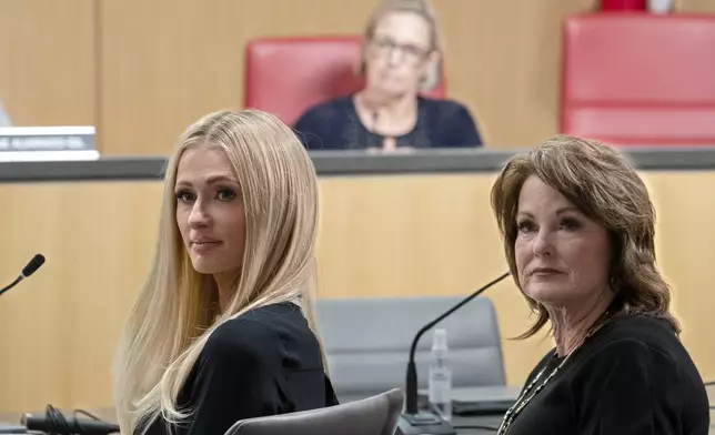 Hotel heiress and media personalty Paris Hilton, left, and state Sen. Shannon Grove, R-Bakersfield right, listen as supporters speak in support Grove's proposed bill calling on more transparency for youth treatment facilities licensed by the California Department of Social Services, during a hearing of the Senate Human Services Committee in Sacramento, Calif., Monday, April 15, 2024. (AP Photo/Rich Pedroncelli)