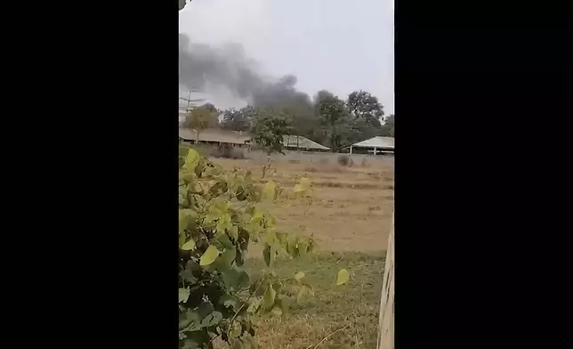 In this image from a video, smoke rises above a distant base, seen from Chbar Mon district in Kompong Speu province, Cambodia Saturday, April 27, 2024. An ammunition explosion at a base in southwestern Cambodia on Saturday afternoon killed multiple soldiers and wounded several others, Prime Minister Hun Manet said. (Chim Sothea via AP)