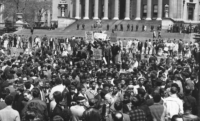 FILE - Demonstrators and students protesting the war in Vietnam are seen at the plaza in front of Columbia University's Low Memorial Library in New York, April 27, 1968. Policemen line the steps of the library, one of five buildings that protesters continue to occupy during the sit-in. (AP Photo/John Duricka, File)