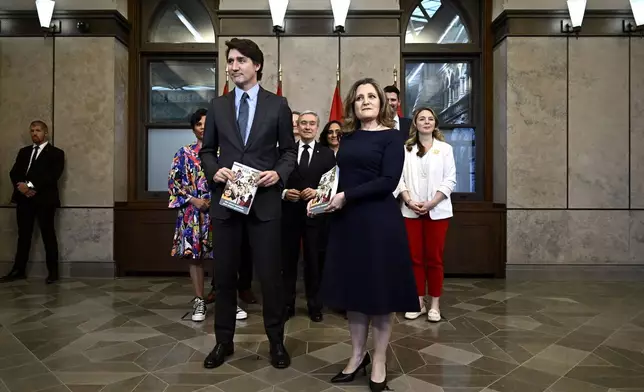 Canada's Prime Minister Justin Trudeau, left, Deputy Prime Minister, Minister of Finance Chrystia Freeland and cabinet ministers pose for a photo before the tabling of the federal budget on Parliament Hill in Ottawa, Ontario, on Tuesday, April 16, 2024. (Justin Tang/The Canadian Press via AP)