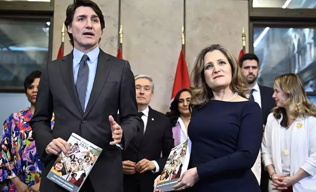 Canada's Prime Minister Justin Trudeau, Deputy Prime Minister, Minister of Finance Chrystia Freeland and cabinet ministers pose for a photo before the tabling of the federal budget on Parliament Hill in Ottawa, Ontario, on Tuesday, April 16, 2024. (Justin Tang/The Canadian Press via AP)