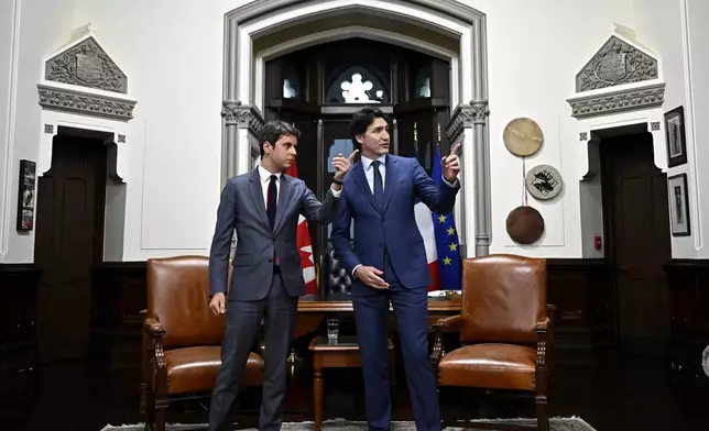 Prime Minister of Canada Justin Trudeau, right, and Prime Minister of France Gabriel Attal, look around the Prime Minister's office in West Block on Parliament Hill, before a meeting in Ottawa on Thursday, April 11, 2024. (Justin Tang/The Canadian Press via AP)