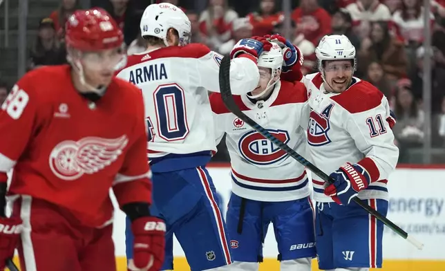Montreal Canadiens right wing Brendan Gallagher (11) celebrates his goal with Joel Armia (40) and Lane Hutson (48) in the first period of an NHL hockey game Monday, April 15, 2024, in Detroit. (AP Photo/Paul Sancya)