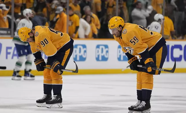 Nashville Predators center Ryan O'Reilly (90) and defenseman Roman Josi (59) skate off the ice after the team 2-1 loss against the Vancouver Canucks in Game 3 of an NHL hockey Stanley Cup first-round playoff series Friday, April 26, 2024, in Nashville, Tenn. (AP Photo/George Walker IV)