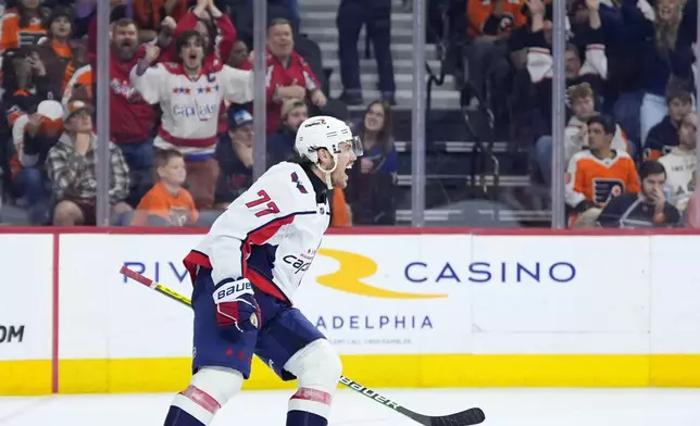 Washington Capitals' T.J. Oshie, left, celebrates after scoring a goal during the third second period of an NHL hockey game against the Philadelphia Flyers, Tuesday, April 16, 2024, in Philadelphia. (AP Photo/Matt Slocum)