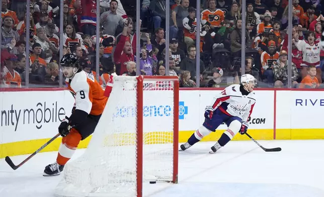 Washington Capitals' T.J. Oshie, right, celebrates after scoring a goal against Philadelphia Flyers' Jamie Drysdale during the third second period of an NHL hockey game, Tuesday, April 16, 2024, in Philadelphia. (AP Photo/Matt Slocum)