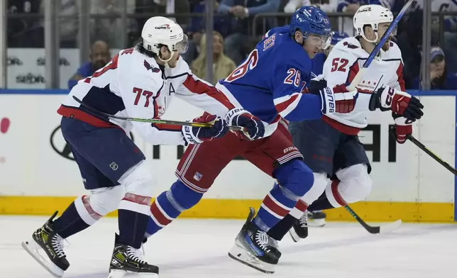 New York Rangers' Jimmy Vesey, center, races for the puck with Washington Capitals' T.J. Oshie, left, and Dylan McIlrath during the first period in Game 1 of an NHL hockey Stanley Cup first-round playoff series, Sunday, April 21, 2024, in New York. (AP Photo/Seth Wenig)