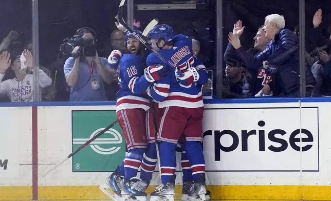 New York Rangers' Vincent Trocheck, left, celebrates after a goal by Artemi Panarin during the second period in Game 1 of an NHL hockey Stanley Cup first-round playoff series against the Washington Capitals, Sunday, April 21, 2024, in New York. (AP Photo/Seth Wenig)
