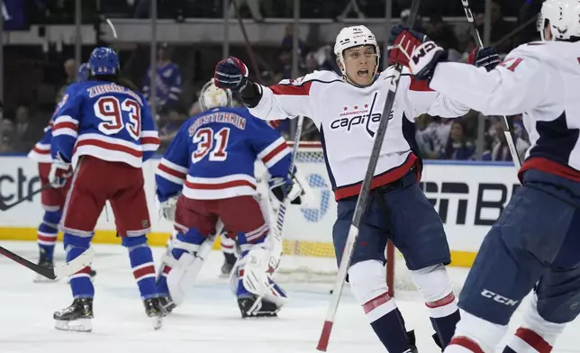 Washington Capitals' Martin Fehervary, center right, reacts after scoring during the second period in Game 1 of an NHL hockey Stanley Cup first-round playoff series against the New York Rangers, Sunday, April 21, 2024, in New York. (AP Photo/Seth Wenig)
