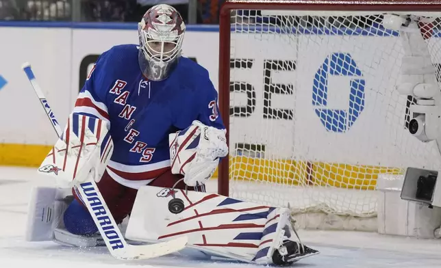 New York Rangers goaltender Igor Shesterkin makes a save during the second period in Game 1 of an NHL hockey Stanley Cup first-round playoff series against the Washington Capitals, Sunday, April 21, 2024, in New York. (AP Photo/Seth Wenig)