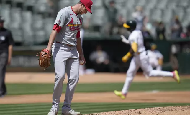 St. Louis Cardinals pitcher Steven Matz, left, reacts as Oakland Athletics' Esteury Ruiz, right rear, rounds the bases after hitting a two-run home run during the third inning of a baseball game in Oakland, Calif., Wednesday, April 17, 2024. (AP Photo/Jeff Chiu)