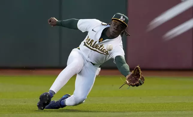 Oakland Athletics right fielder Lawrence Butler dives to catch a fly ball hit by St. Louis Cardinals' Jordan Walker during the fourth inning of a baseball game Monday, April 15, 2024, in Oakland, Calif. (AP Photo/Godofredo A. Vásquez)