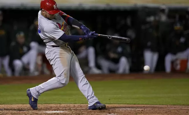 St. Louis Cardinals' Willson Contreras hits an RBI double against the Oakland Athletics during the sixth inning of a baseball game Monday, April 15, 2024, in Oakland, Calif. (AP Photo/Godofredo A. Vásquez)
