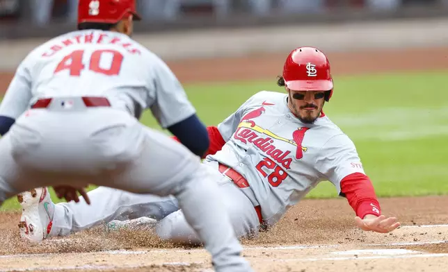St. Louis Cardinals' Nolan Arenado (28) scores against the New York Mets during the first inning of a baseball game, Saturday, April 27, 2024, in New York. (AP Photo/Noah K. Murray)