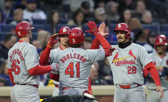 St. Louis Cardinals' Alec Burleson (41) celebrates with Paul Goldschmidt (46) and Nolan Arenado (28) after hitting a three-run home run against the New York Mets during the second inning of a baseball game Friday, April 26, 2024, in New York. (AP Photo/Frank Franklin II)