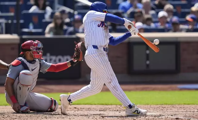 New York Mets' Francisco Lindor, right, hits a solo home run during the sixth inning of a baseball game against the St. Louis Cardinals at Citi Field, Sunday, April 28, 2024, in New York. (AP Photo/Seth Wenig)