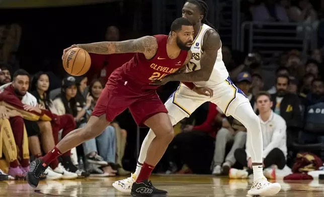 Cleveland Cavaliers forward Marcus Morris Sr. (24) dribbles under pressure from Los Angeles Lakers forward Taurean Prince (12) during the first half of an NBA basketball game Saturday, April 6, 2024, in Los Angeles. (AP Photo/William Liang)