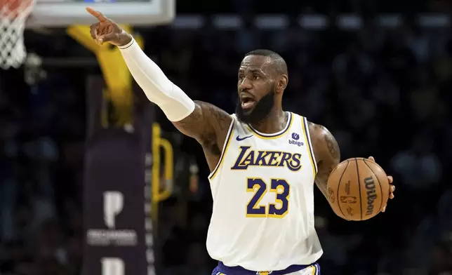 Los Angeles Lakers forward LeBron James (23) directs his teammates as he dribbles up the court during the first half of an NBA basketball game against the Cleveland Cavaliers, Saturday, April 6, 2024, in Los Angeles. (AP Photo/William Liang)