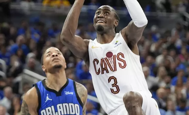 Cleveland Cavaliers guard Caris LeVert (3) shoots in front of Orlando Magic guard Markelle Fultz during the first half of Game 3 of an NBA basketball first-round playoff series Thursday, April 25, 2024, in Orlando, Fla. (AP Photo/John Raoux)