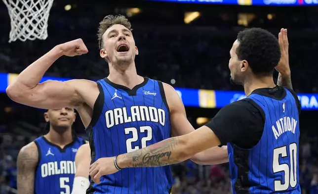 Orlando Magic forward Franz Wagner (22) celebrates with guard Cole Anthony (50) after making a basket and drawing a foul during the second half against the Cleveland Cavaliers in Game 4 of an NBA basketball first-round playoff series, Saturday, April 27, 2024, in Orlando, Fla. (AP Photo/John Raoux)