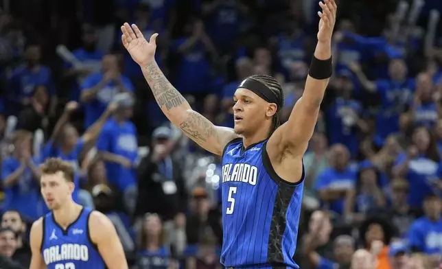 Orlando Magic forward Paolo Banchero (5) waves his arms to the fans to cheer during the second half of Game 4 of an NBA basketball first-round playoff series against the Cleveland Cavaliers, Saturday, April 27, 2024, in Orlando, Fla. (AP Photo/John Raoux)
