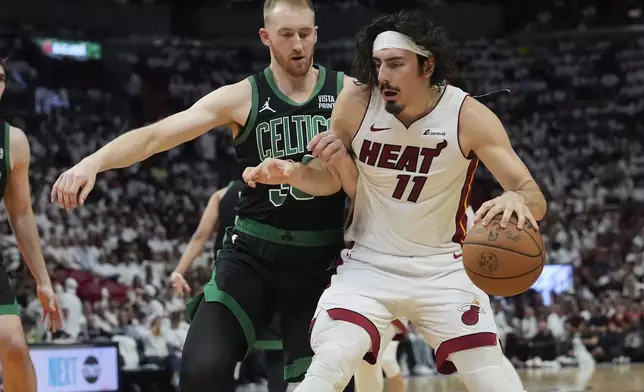 Boston Celtics forward Sam Hauser (30) defends Miami Heat guard Jaime Jaquez Jr. (11) during the second half of Game 4 of an NBA basketball first-round playoff series, Monday, April 29, 2024, in Miami. (AP Photo/Marta Lavandier)