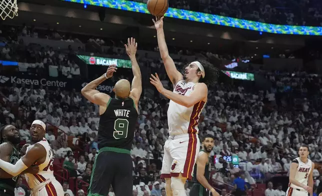 Miami Heat guard Jaime Jaquez Jr., center right, aims to score as Boston Celtics guard Derrick White (9) defends during the second half of Game 4 of an NBA basketball first-round playoff series, Monday, April 29, 2024, in Miami. (AP Photo/Marta Lavandier)