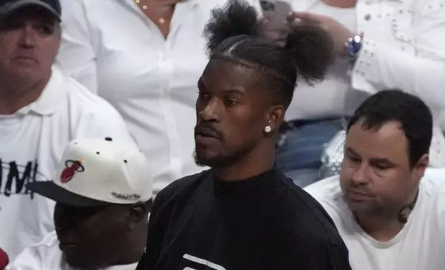 Miami Heat forward Jimmy Butler looks on from the bench during the first half of Game 3 of an NBA basketball first-round playoff series against the Boston Celtics, Saturday, April 27, 2024, in Miami. (AP Photo/Wilfredo Lee)