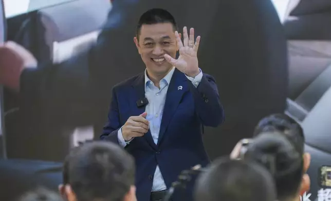 Founder and CEO of the electric car manufacturer Nio, William Li, waves to the media during a press conference at the opening of the China Auto Show in Beijing, China, Thursday, April 25, 2024. (AP Photo/Tatan Syuflana)