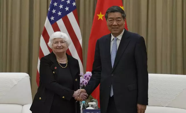 U.S. Treasury Secretary Janet Yellen, left, shakes hands with Chinese Vice Premier He Lifeng as they arrive for a one-to-one meeting at the Guangdong Zhudao Guest House in southern China's Guangdong province, Saturday, April 6, 2024. (AP Photo/Andy Wong, Pool)