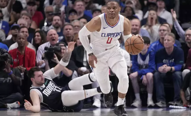 Los Angeles Clippers guard Russell Westbrook (0) comes away with a steal from Dallas Mavericks' Luka Doncic, left, during the first half of Game 2 of an NBA basketball first-round playoff series Friday, April 26, 2024, in Dallas. (AP Photo/Tony Gutierrez)