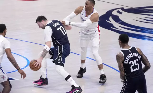 Dallas Mavericks' Luka Doncic (77) is fouled by Los Angeles Clippers' Russell Westbrook, right, during the second half of Game 2 of an NBA basketball first-round playoff series in Dallas, Friday, April 26, 2024. (AP Photo/Tony Gutierrez)