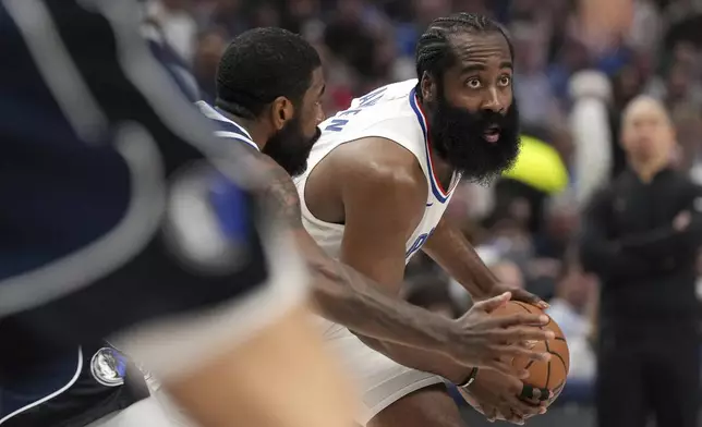 Los Angeles Clippers guard James Harden looks to pass as Dallas Mavericks guard Kyrie Irving defends during the first half of Game 4 of an NBA basketball first-round playoff series, Sunday, April 28, 2024, in Dallas. (AP Photo/Jeffrey McWhorter)