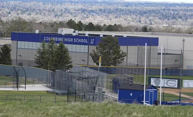 A view of Columbine High School from rebel hill at the Columbine Memorial, Wednesday, April 17, 2024, in Littleton, Colo. Trauma still shadows the survivors of the horrific Columbine High School shooting as the attack's 25th anniversary approaches. (AP Photo/David Zalubowski)