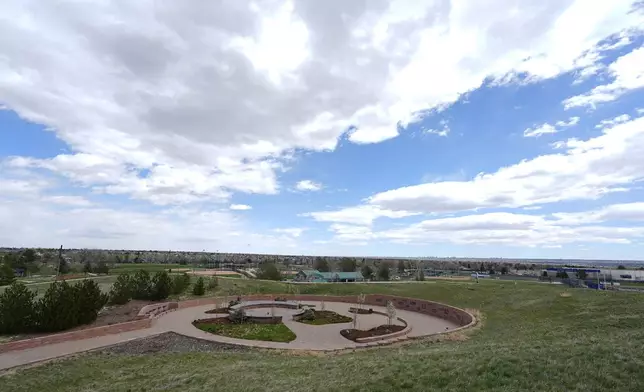 Clouds stream over the Columbine Memorial, Wednesday, April 17, 2024, in Littleton, Colo. Trauma still shadows the survivors of the horrific Columbine High School shooting as the attack's 25th anniversary approaches. (AP Photo/David Zalubowski)