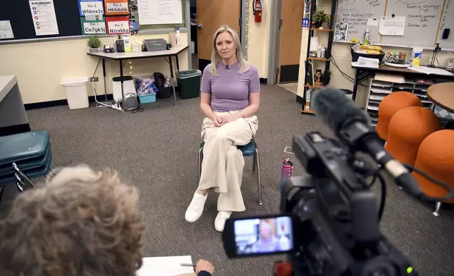Heather Martin is interviewed in Aurora, Colo., on Thursday, April 11, 2024. Martin, a survivor of the 1999 shooting at Columbine High School in suburban Denver, hid with 60 other students in a barricaded office during the attack. It's been a quarter-century since two gunmen killed 12 fellow students and a teacher at the school, and the trauma of that day continues to shadow Martin and others who were there. (AP Photo/Thomas Peipert)