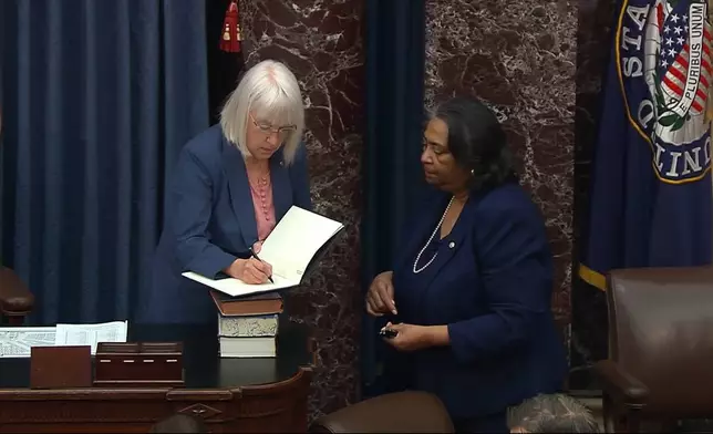 In this image from video from Senate Television, Sen. Patty Murray, D-Wash., signs the impeachment book for Secretary of the Senate Sonceria Berry during the impeachment trial of Homeland Security Secretary Alejandro Mayorkas on the Senate floor at the U.S. Capitol, Wednesday, April 17, 2024, in Washington. (Senate Television via AP)