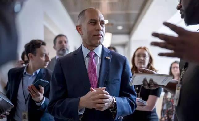 House Minority Leader Hakeem Jeffries, D-N.Y., walks with reporters after lawmakers pushed a $95 billion national security aid package for Ukraine, Israel and other U.S. allies closer to passage, at the Capitol in Washington, Friday, April 19, 2024. (AP Photo/J. Scott Applewhite)