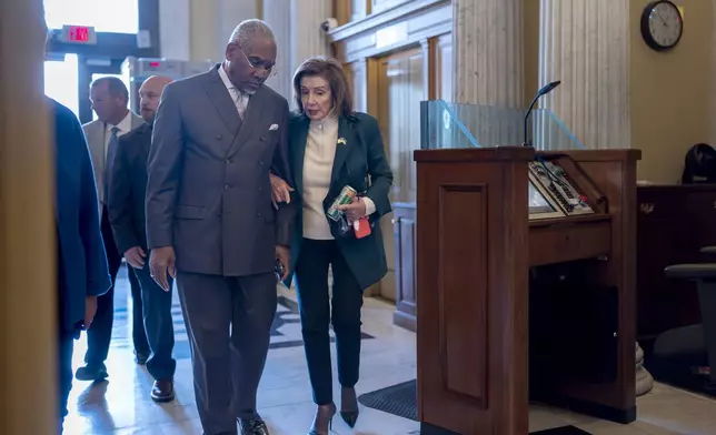 Rep. Gregory Meeks, D-N.Y., the ranking member of the House Foreign Affairs Committee, left, walks with Rep. Nancy Pelosi, D-Calif., the speaker emerita, as lawmakers arrive to vote on approval of $95 billion in foreign aid for Ukraine, Israel and other U.S. allies. (AP Photo/J. Scott Applewhite)