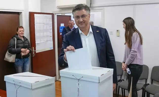 Prime Minister incumbent Andrej Plenkovic casts his ballot at a polling station in Zagreb, Croatia, Wednesday, April 17, 2024. Croatia is voting in a parliamentary election after a campaign that centered on a bitter rivalry between the president and prime minister of the small European Union and NATO member. (AP Photo/Darko Vojinovic)
