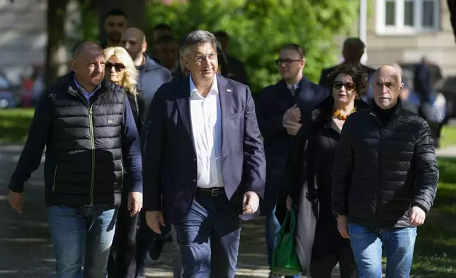 Prime Minister incumbent Andrej Plenkovic, center, leaves a polling station after voting at a polling station in Zagreb, Croatia, Wednesday, April 17, 2024. Croatia is voting in a parliamentary election after a campaign that centered on a bitter rivalry between the president and prime minister of the small European Union and NATO member. (AP Photo/Darko Vojinovic)