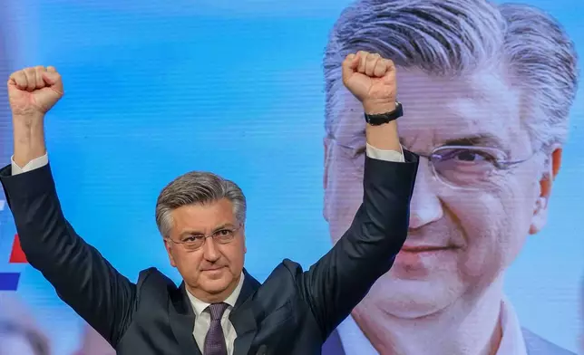 Prime Minister incumbent Andrej Plenkovic waves after claiming victory in a parliamentary election in Zagreb, Croatia, Thursday, April 18, 2024. Croatia's governing conservatives convincingly won a highly contested parliamentary election Wednesday, but will still need support from far-right groups to stay in power, according to the official vote count. The election followed a campaign that centered on a bitter rivalry between the country's president and prime minister. (AP Photo/Darko Vojinovic)